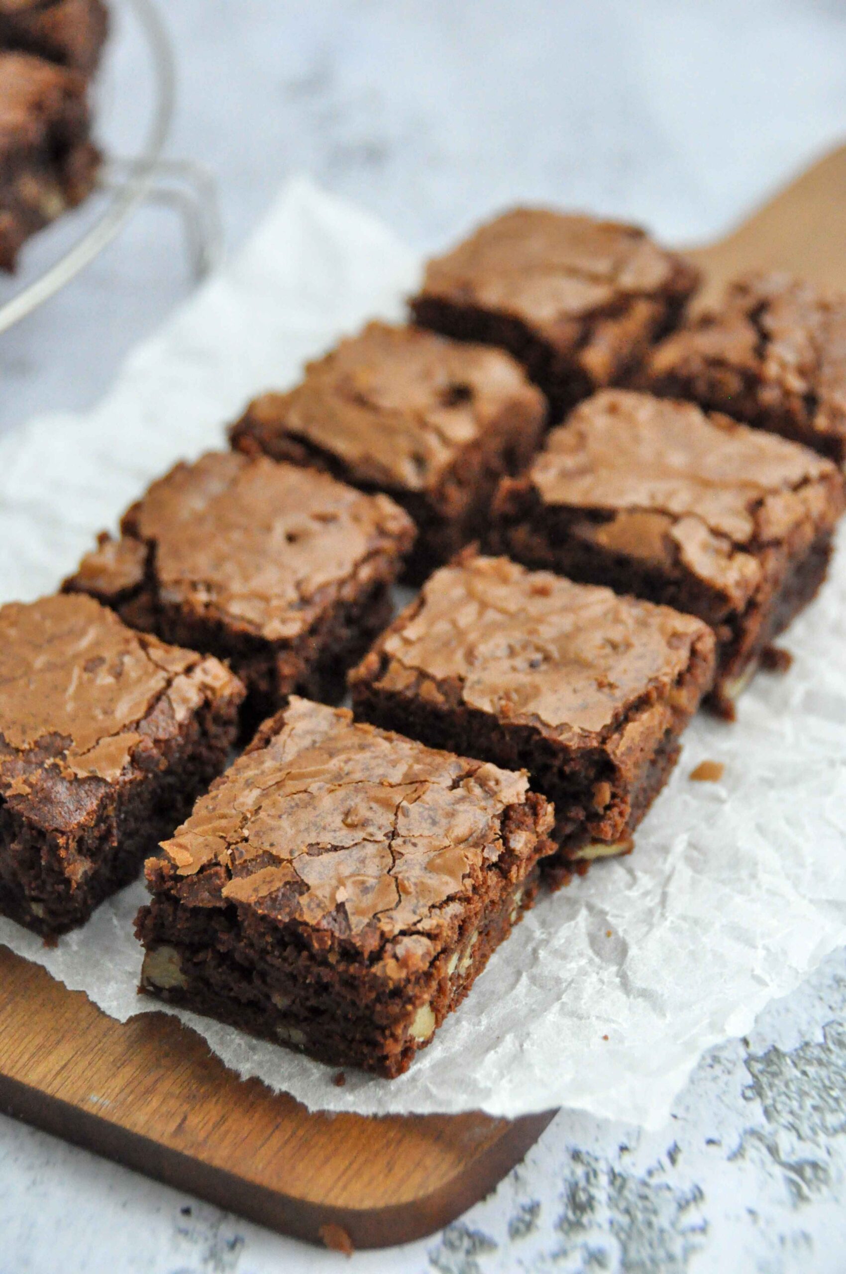 Two rows of chewy, fudgy brown butter brownies on a wooden board