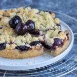 Cherry Crumble Bars with a cut slice