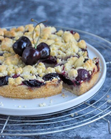 Cherry Crumble Bars with a cut slice