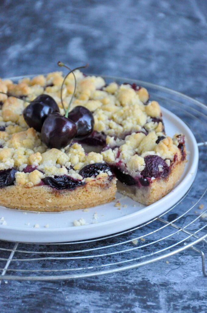 Cherry Crumble Bars with a cut slice