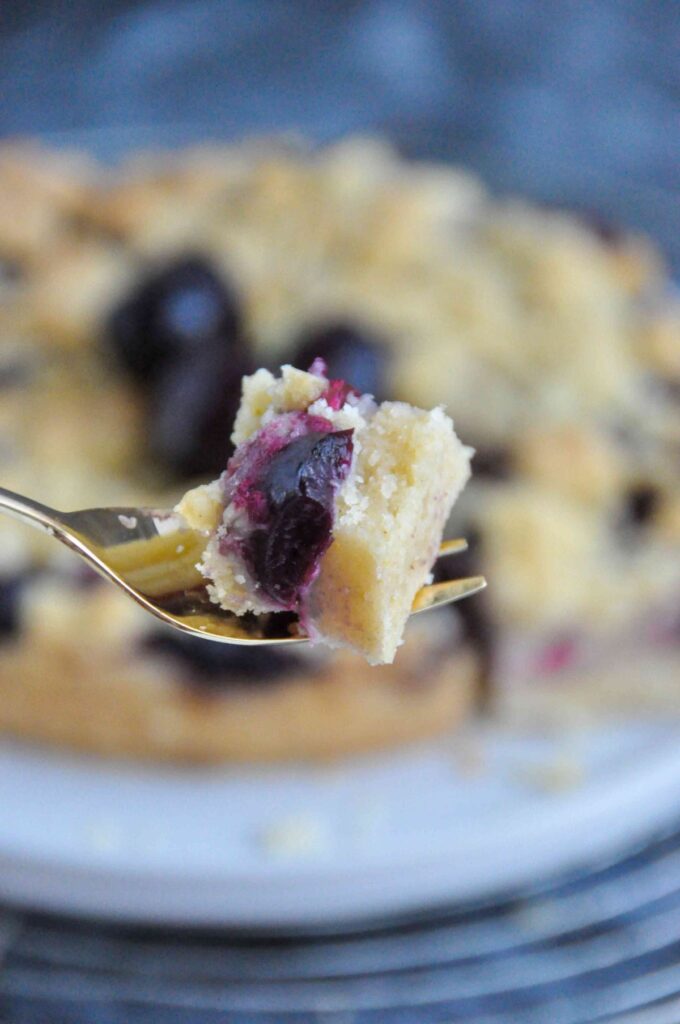 Cherry Crumble Bars on cooling rack and bite on fork