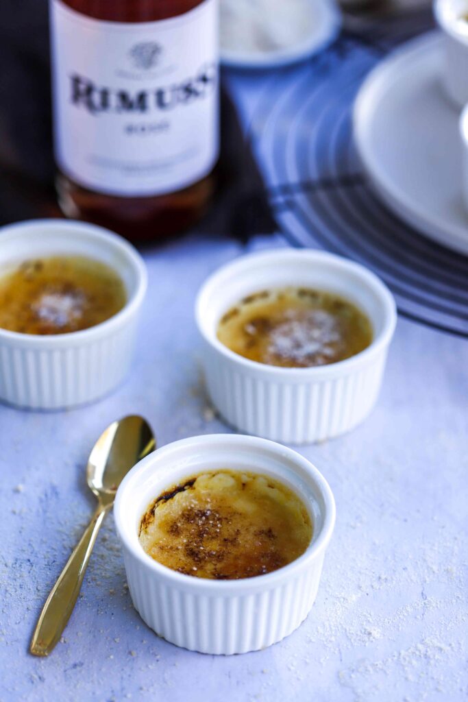 Crème Brûlée with sparkling wine, front view with bottle