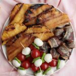 Summer BBQ appetizers: grilled pineapple, caprese sticks and bacon-wrapped prunes