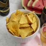 Bowl of Tortilla Chips, watermelon in background